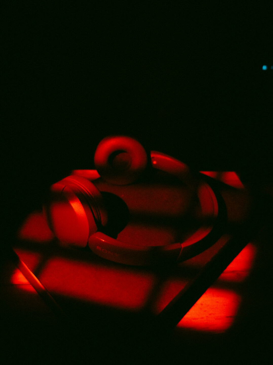 Dramatic close-up of a broadcast microphone in dark studio lighting
